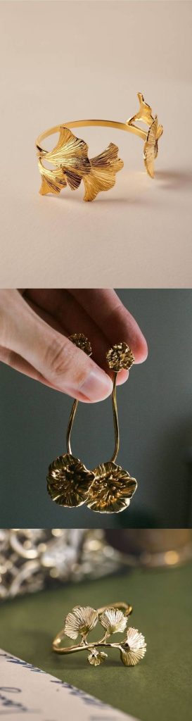 Collage of Australian floral-inspired gold jewellery, featuring a detailed gold bracelet shaped like ginkgo leaves, long dangling gold earrings with flower motifs, and a gold ring designed with delicate botanical patterns.