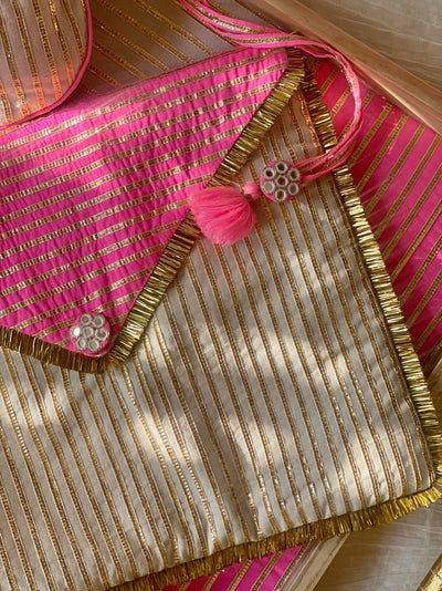 Indian wrapping using bright pink and gold embroidered festive fabric.