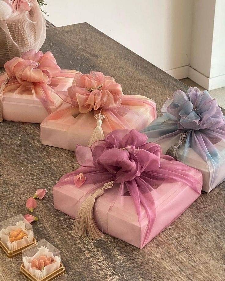 Korean bojagi wrapping with sheer pastel fabrics and tassel embellishments.