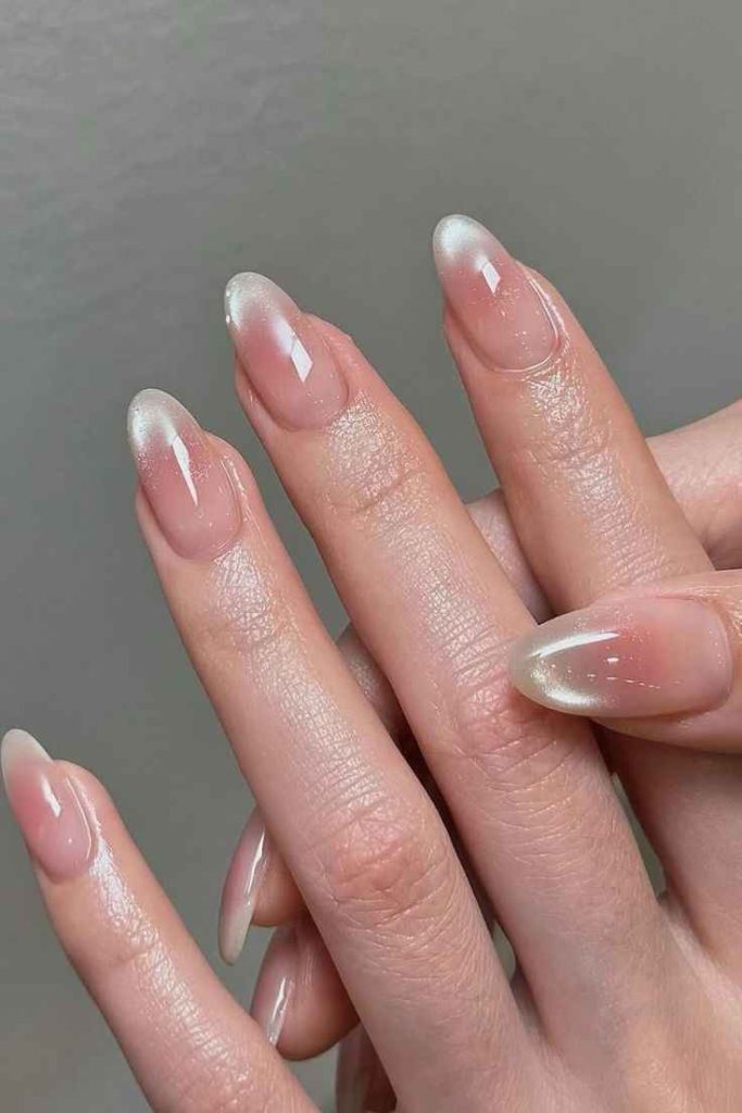 Soft pink and white ombre nails with a glossy finish