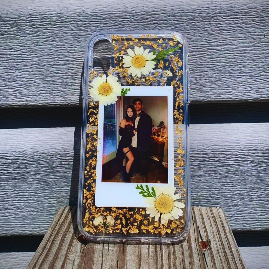 Custom phone cases with pressed flowers and photo inserts.
