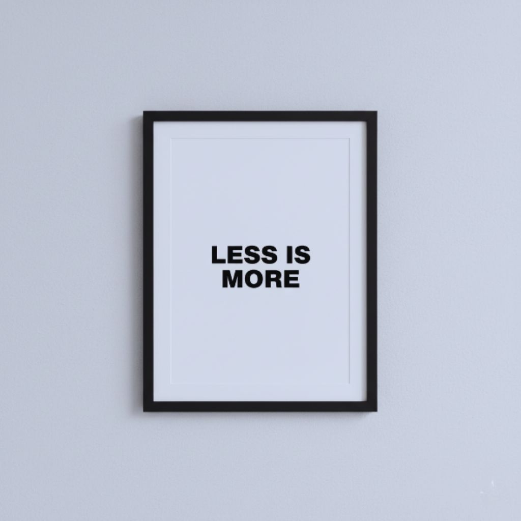 Minimalist black-and-white wall art print with the quote “Less Is More” in bold font.