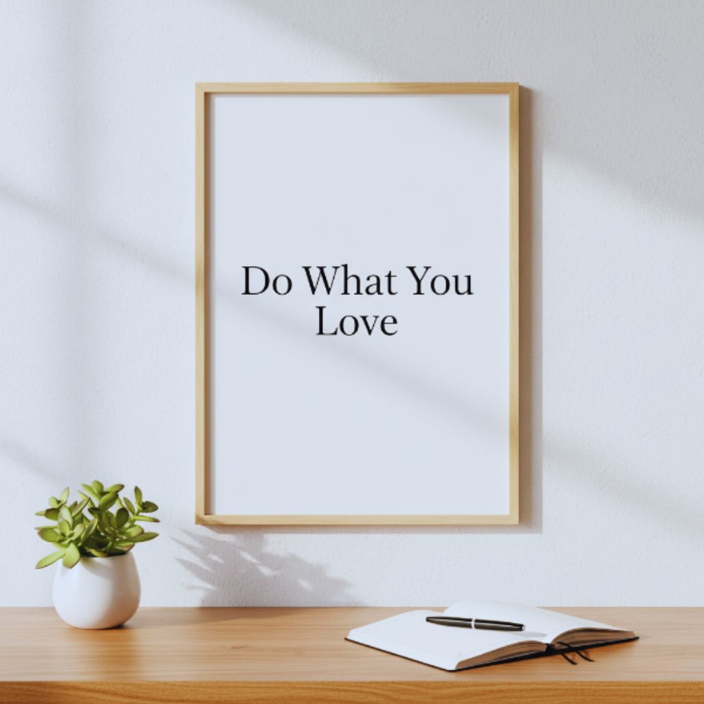 Minimalist wall art print reading “Do What You Love” above a modern desk.