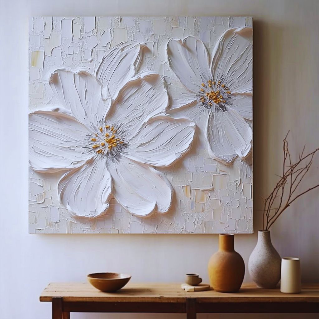 DIY wall art with leaf and flower imprints pressed into textured white putty for a natural aesthetic.