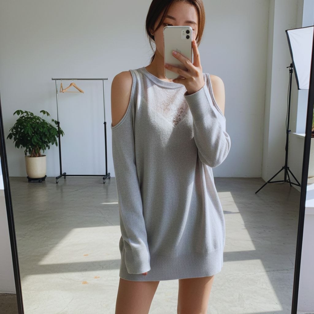 A woman wearing a cut-out top layered with lace underneath, representing edgy DIY fashion.