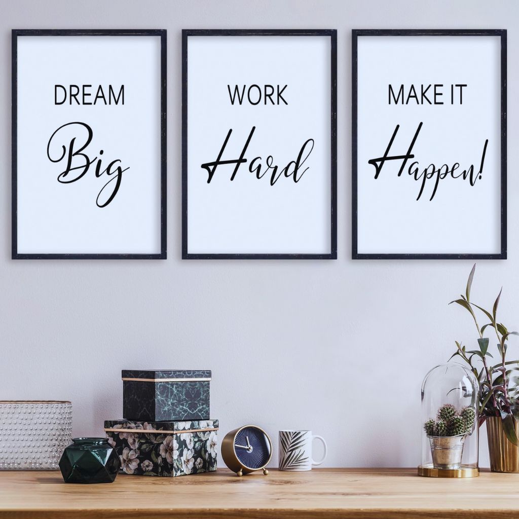 Floating glass frames with black-and-white typography art on a minimalist textured wall.