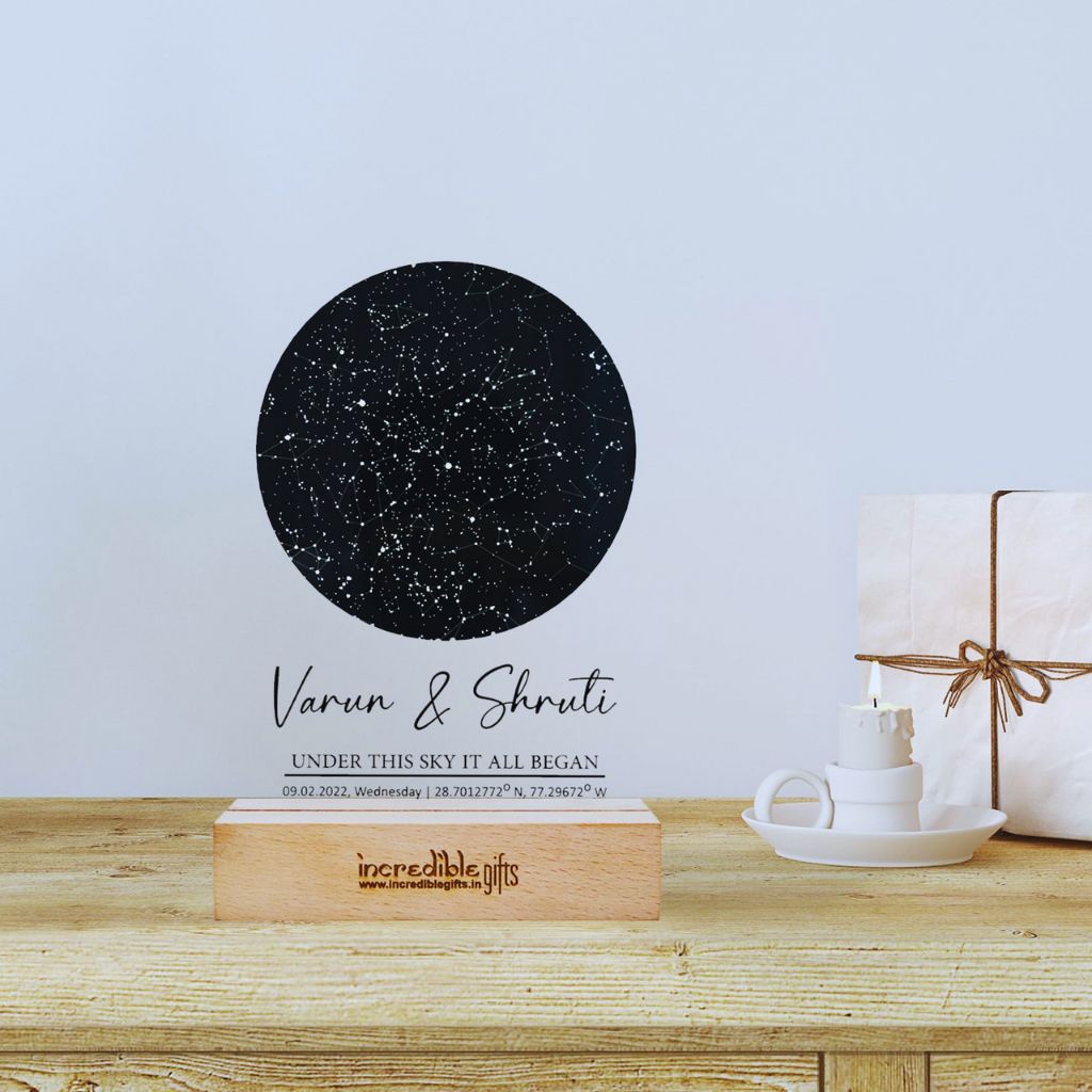 “Personalized star map and moon phase clock from Uncommon Goods on a minimalist shelf.”