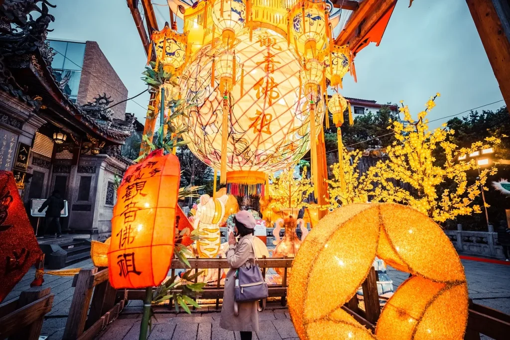 “Woman admiring colorful lanterns at Chinese Lantern Festival with glowing lights and traditional decorations”