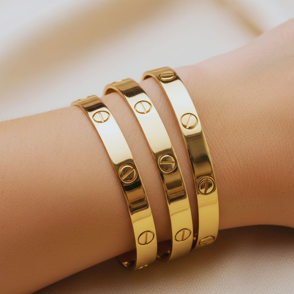 “Gold screw-motif bangles stacked on a wrist as Cartier Love Bracelet dupes.”