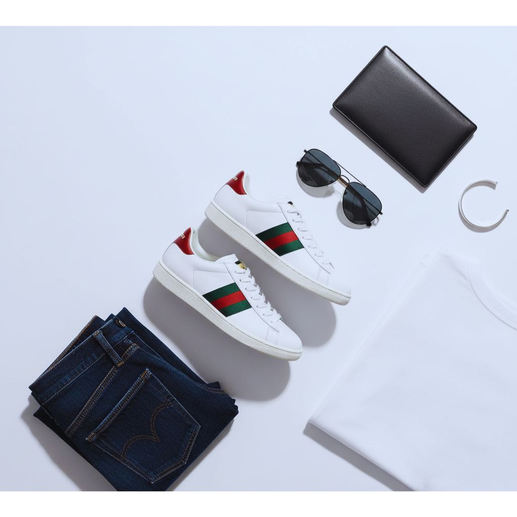 “White sneakers with red and green side stripes styled on a white background as Gucci Ace dupes.”