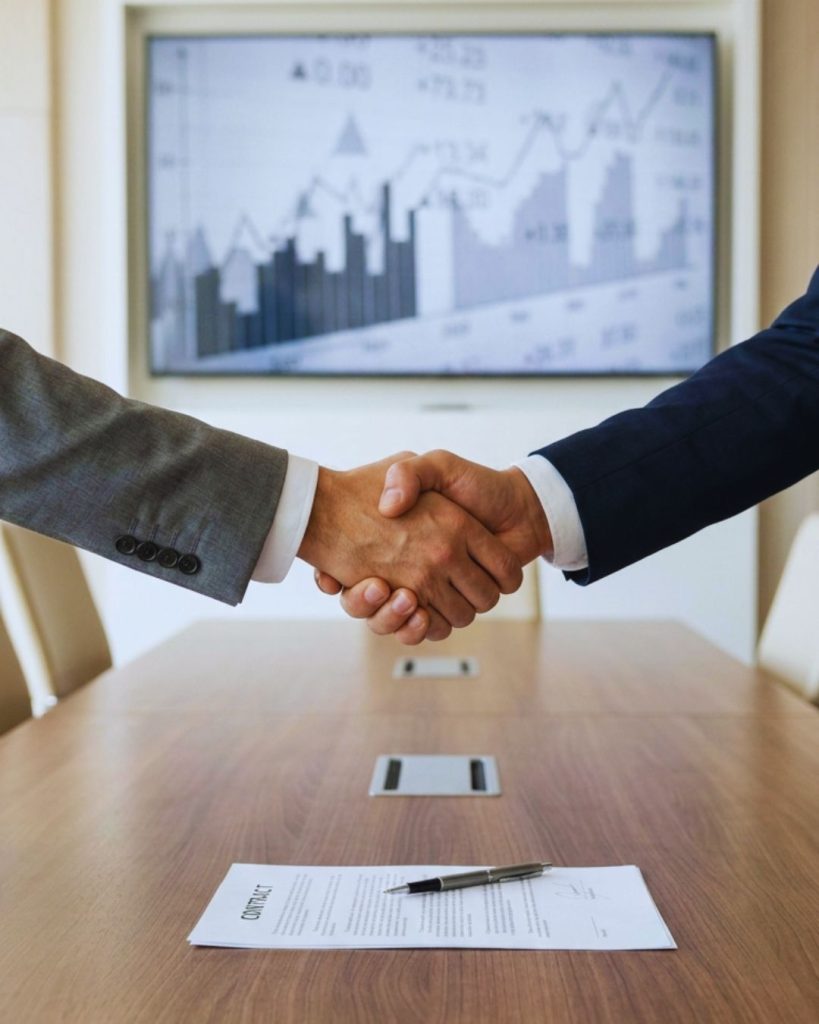 Professional closing business deal symbolizing salary advantage linked to attractiveness.